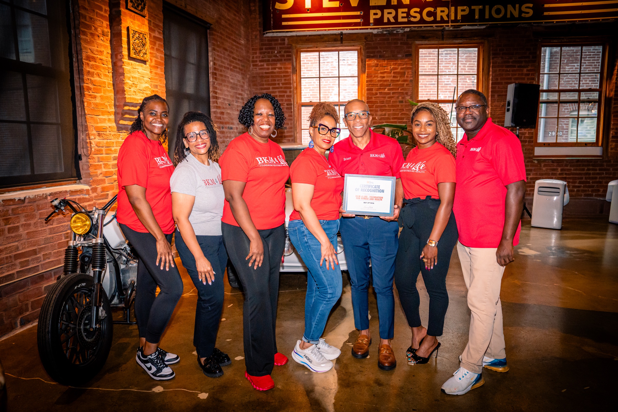 BKM 4 Life Foundation team members celebrating Nike grant recognition while holding the recognition certificate